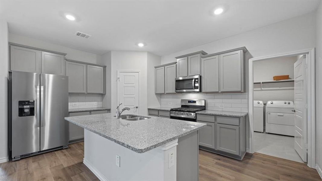 Kitchen featuring gray cabinetry, appliances with stainless steel finishes, light stone counters, and recessed lighting Kitchen featuring gray cabinetry, appliances with stainless steel finishes, light stone counters, and recessed lighting