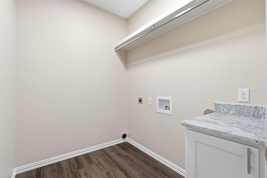 Laundry room with dark wood-type flooring, electric dryer hookup, and washer hookup