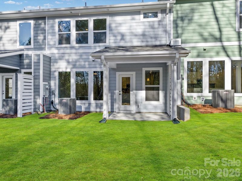 Enjoy your morning coffee from the back covered porch with views of the wooded homesite