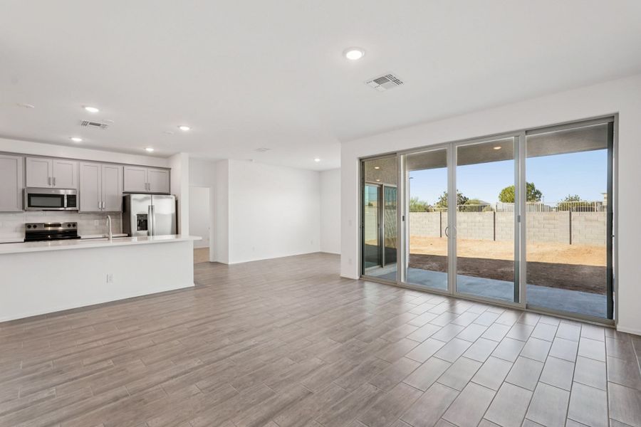 Great room, kitchen and dining. Finishes and options may vary by community