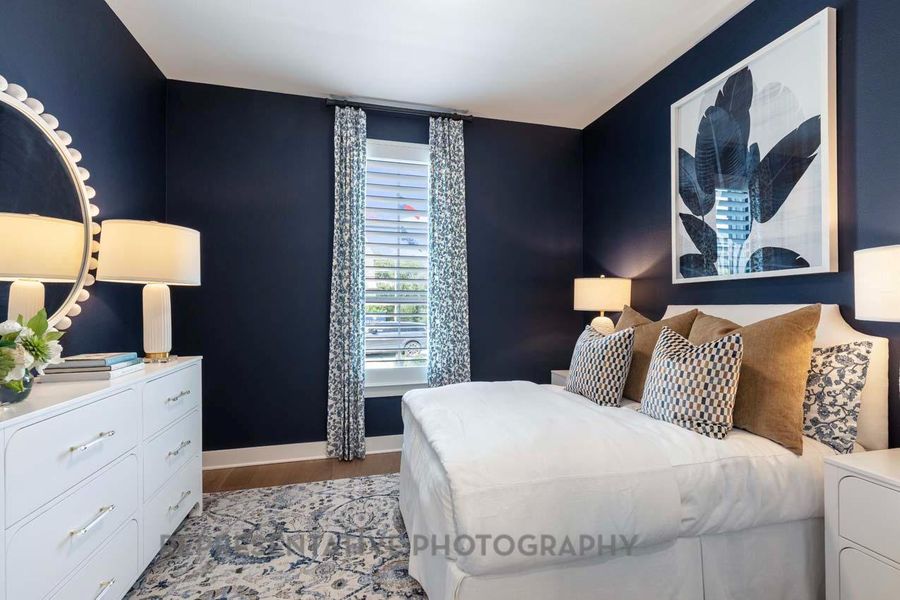 Bedroom with light wood finished floors and baseboards Bedroom with light wood finished floors and baseboards