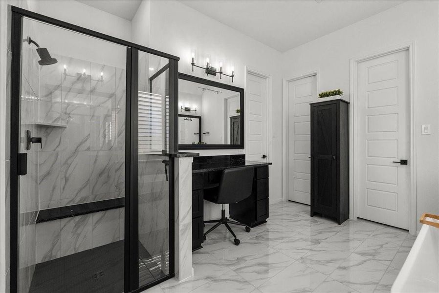 The luxurious primary en-suite bath features dual vanities, a walk-in shower, soaking tub, and separate his-and-her walk-in closets.
