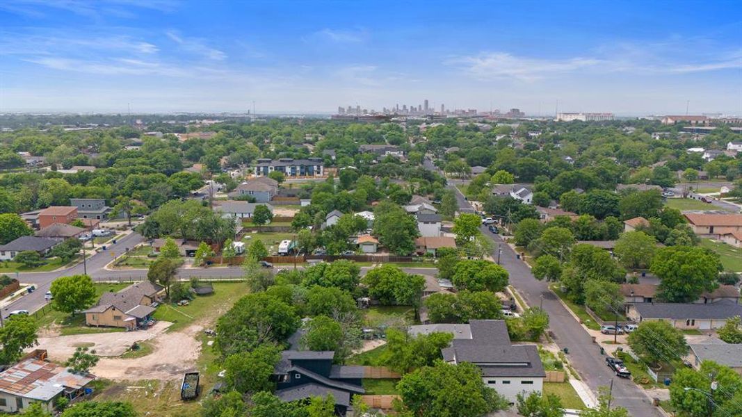 The north side of the house is visible in the foreground and the Austin city skyline in the background.