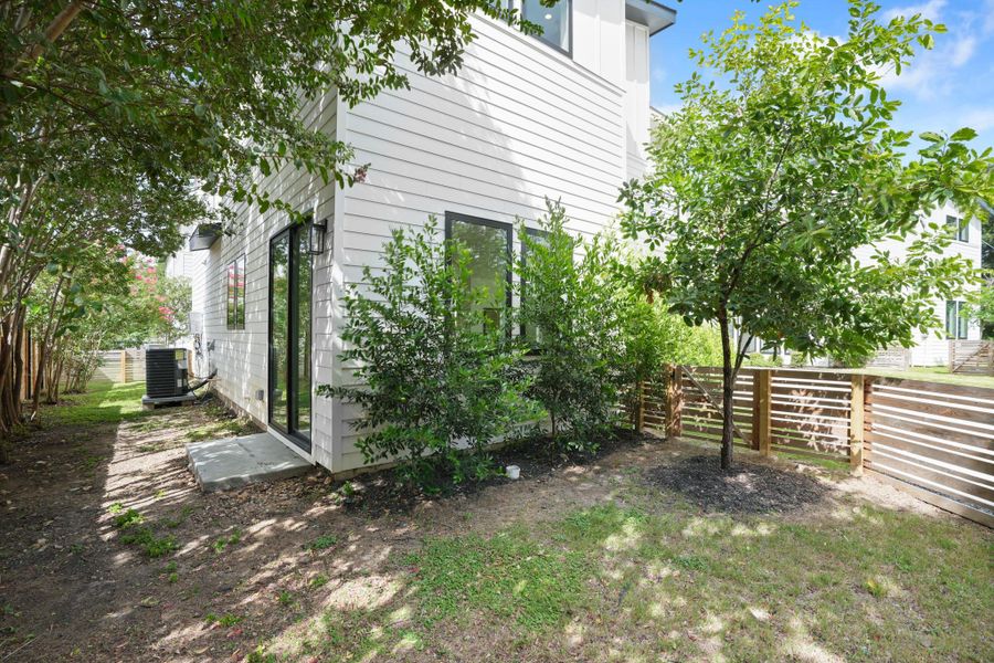 A private side yard with modern fencing offers serene outdoor living. A private side yard with modern fencing offers serene outdoor living.