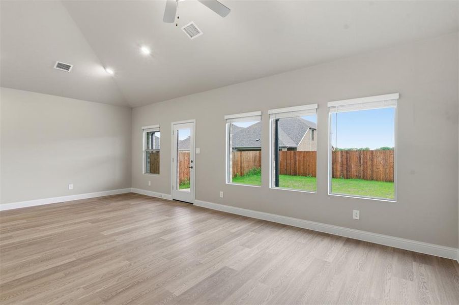 Spacious room with a vaulted ceiling, recessed lighting, and a ceiling fan