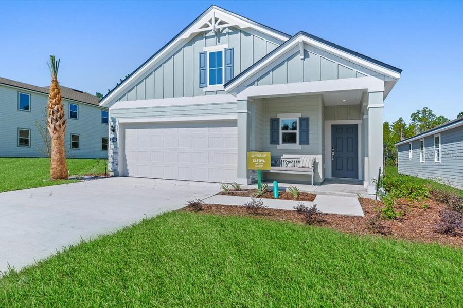 Front exterior of a new home in Palm Series at Seminole Palms, Palm Coast, FL, highlighting curb appeal (Image 1).