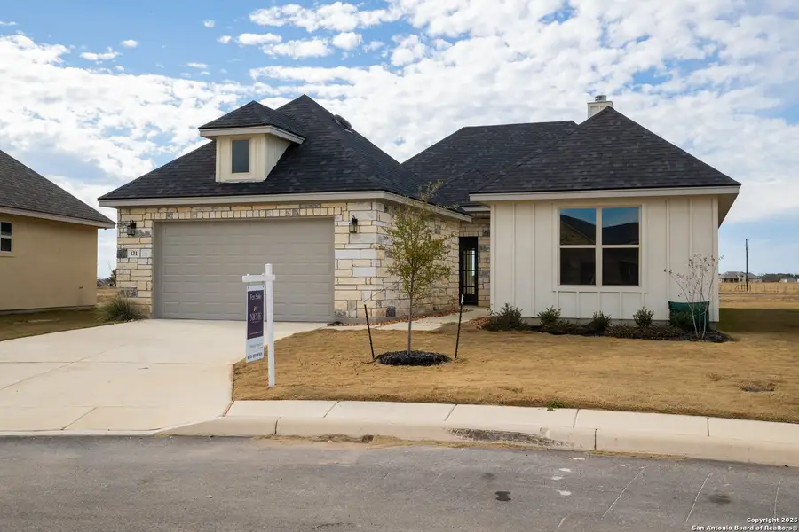 Front exterior of a new home in Boehme Ranch, Castroville, TX, highlighting curb appeal (Image 2). Front exterior of a new home in Boehme Ranch, Castroville, TX, highlighting curb appeal (Image 2).