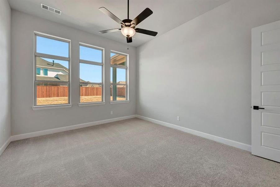 Unfurnished room with light colored carpet and ceiling fan