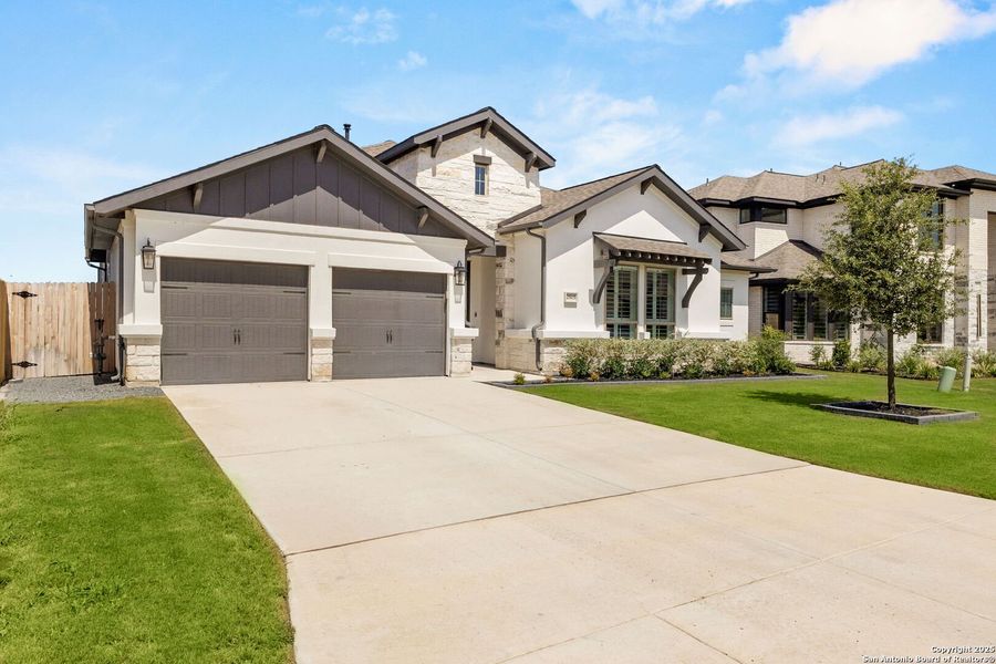 Front exterior of a new home in Meadows Of Mill Creek 60', Seguin, TX, highlighting curb appeal (Image 2).