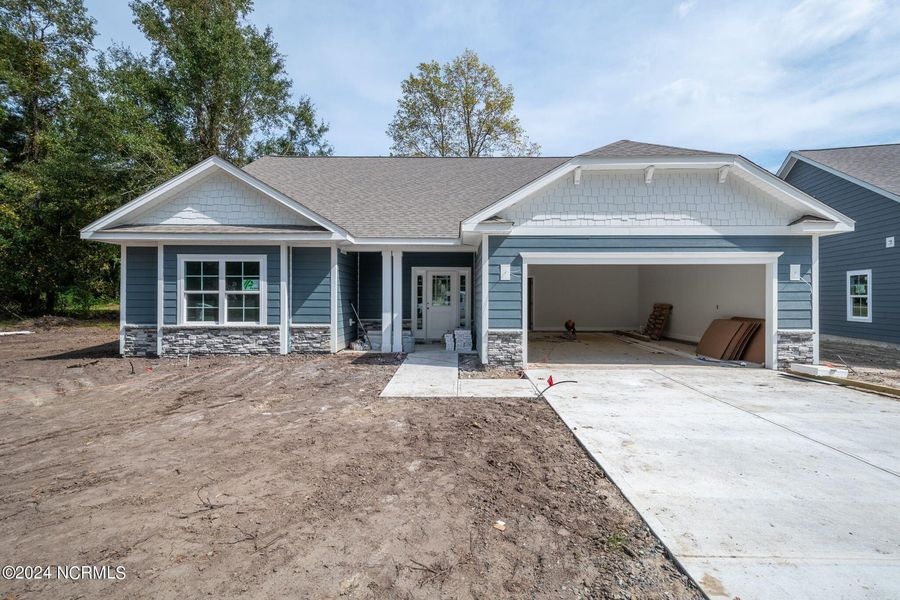 Front exterior of a new home in River Village Square in River Landing, Wallace, NC, highlighting curb appeal (Image 1). Front exterior of a new home in River Village Square in River Landing, Wallace, NC, highlighting curb appeal (Image 1).