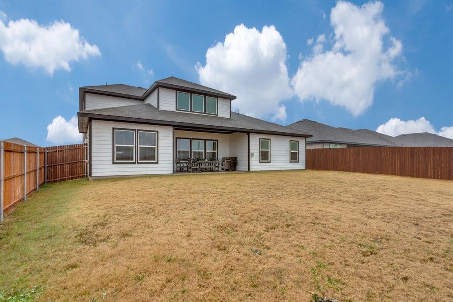 Rear view of property featuring a yard