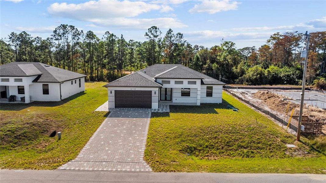 Front exterior of a new home in , Lehigh Acres, FL, highlighting curb appeal (Image 2). Front exterior of a new home in , Lehigh Acres, FL, highlighting curb appeal (Image 2).