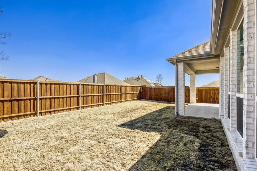 Fenced backyard featuring a patio area
