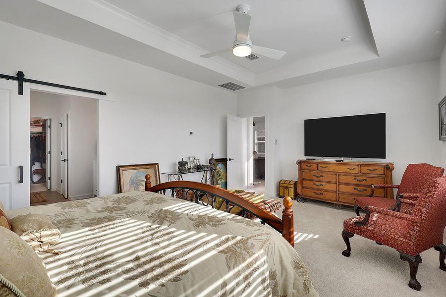 Primary bedroom can accommodate a sitting area! A stylish sliding barn door leads into the lavish primary ensuite.