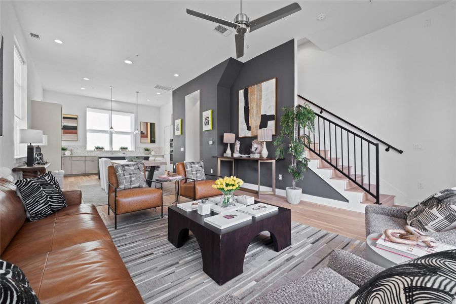 Open-concept living space featuring wood-finish flooring, recessed lighting, and a modern ceiling fan