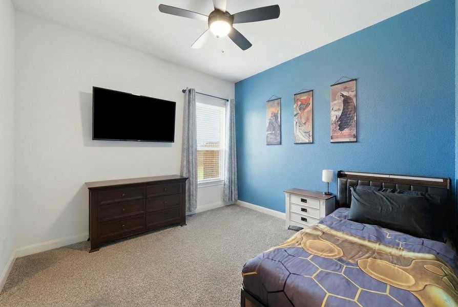 Comfortable bedroom with soft carpeting and a ceiling fan, offering a tranquil retreat. Comfortable bedroom with soft carpeting and a ceiling fan, offering a tranquil retreat.
