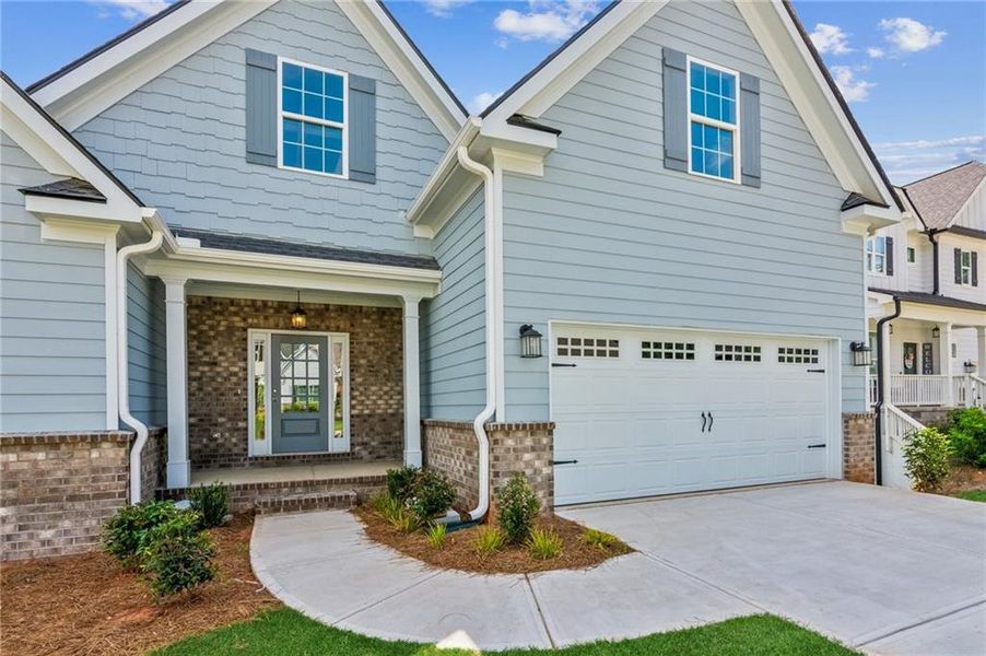Front exterior of a new home in Traditions of Braselton, Jefferson, GA, highlighting curb appeal (Image 17).