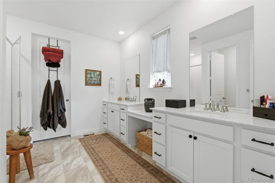 View of primary bath with walk-in closet door
