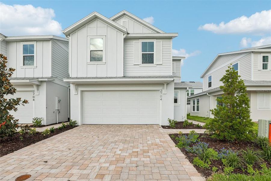 Front exterior of a new home in Cyrene at Harmony, St. Cloud, FL, highlighting curb appeal (Image 1). Front exterior of a new home in Cyrene at Harmony, St. Cloud, FL, highlighting curb appeal (Image 1).