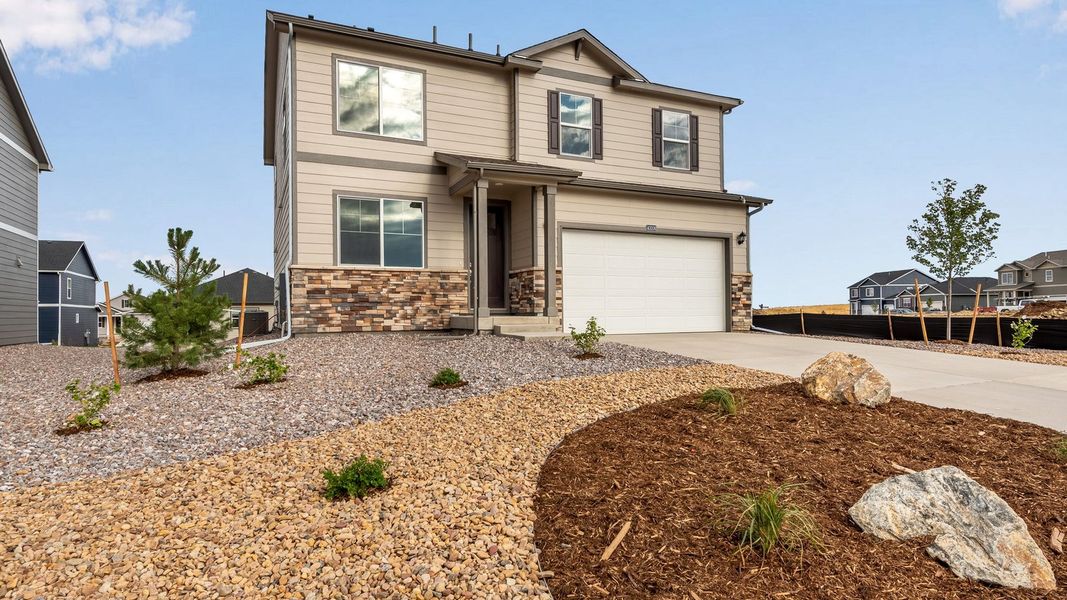 Front exterior of a new home in Spring Valley Ranch, Elizabeth, CO, highlighting curb appeal (Image 2). Front exterior of a new home in Spring Valley Ranch, Elizabeth, CO, highlighting curb appeal (Image 2).