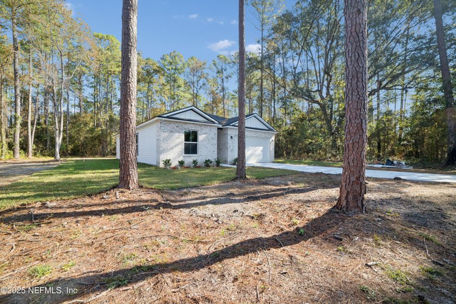Front exterior of a new home in , Jacksonville, FL, highlighting curb appeal (Image 1).
