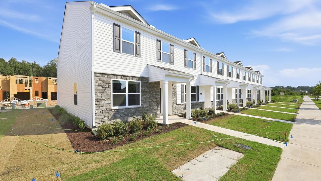 Front exterior of a new home in Clock Road Townhomes, New Bern, NC, highlighting curb appeal (Image 19). Front exterior of a new home in Clock Road Townhomes, New Bern, NC, highlighting curb appeal (Image 19).