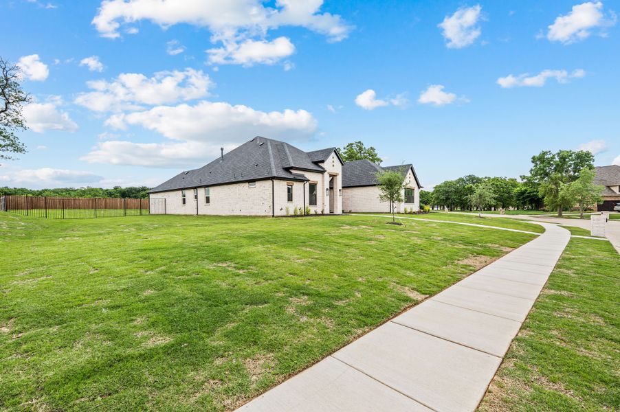 Front exterior of a new home in Highland Oaks, Boyd, TX, highlighting curb appeal (Image 2). Front exterior of a new home in Highland Oaks, Boyd, TX, highlighting curb appeal (Image 2).