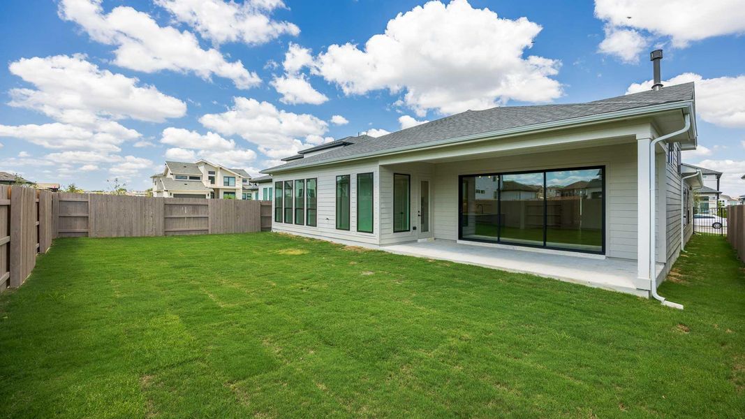 Rear view of house with a fenced backyard, a patio, and roof with shingles Rear view of house with a fenced backyard, a patio, and roof with shingles