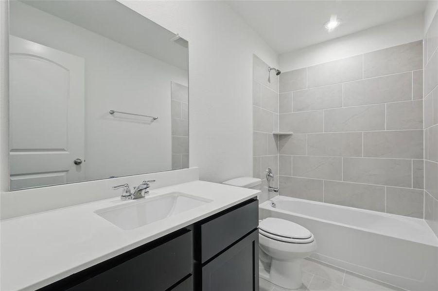 Bathroom with  shower combination, vanity, and light tile patterned flooring