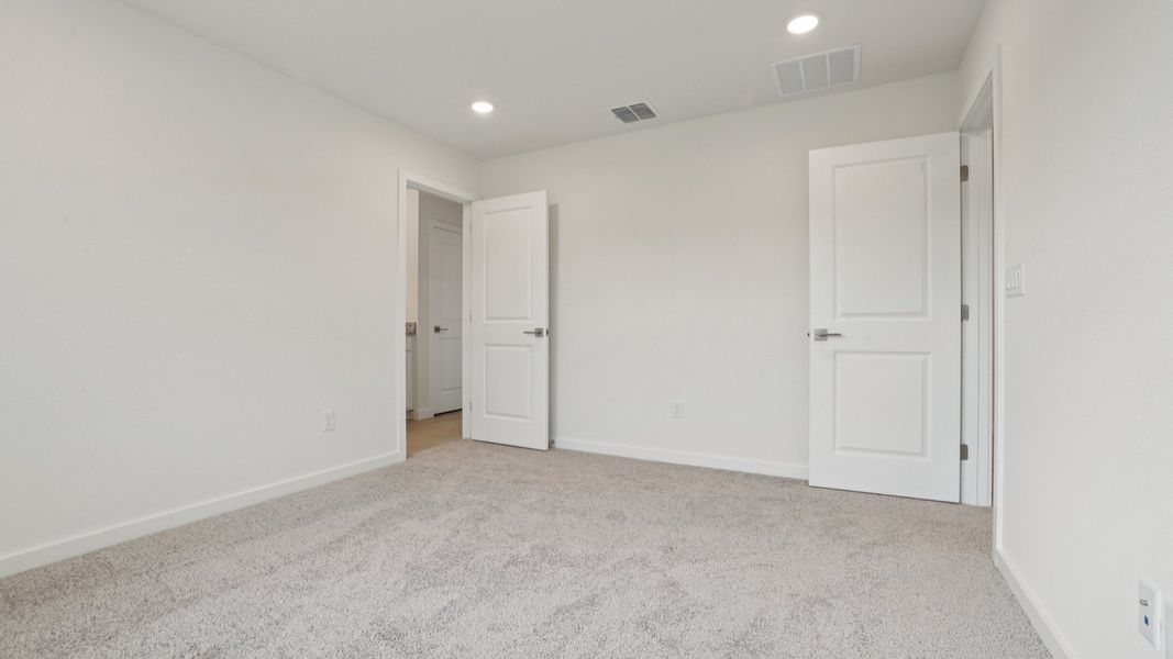 Primary suite with en suite Bath of the Coronado - End at Cyrene at Harmony located in St Cloud FL by DRB Homes