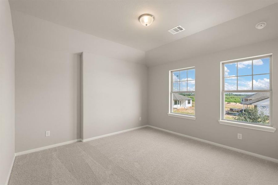 Your secondary bedroom features plush carpet, fresh paint, closet, and a large window that lets in plenty of natural lighting.