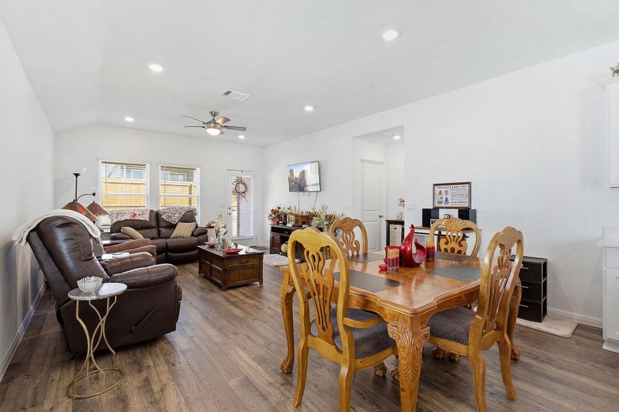 Dining room featuring dark wood finished floors, ceiling fan, recessed lighting, and lofted ceiling