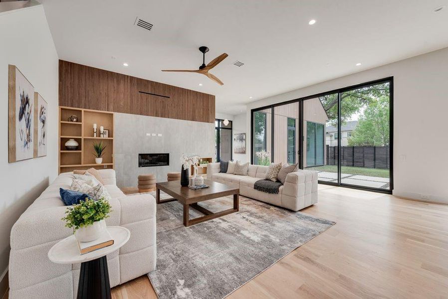 A statement fireplace anchors the space, adding warmth and architectural interest.