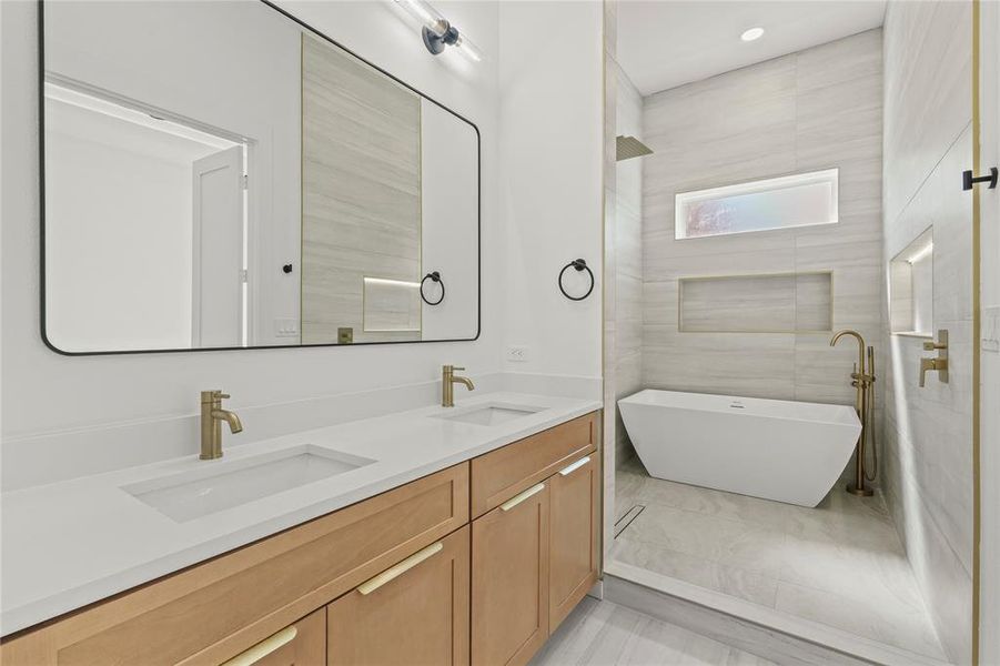 Full bathroom featuring a soaking tub and double vanity