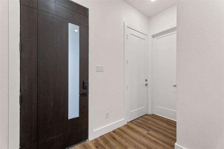 Entryway featuring wood finished floors and baseboards Entryway featuring wood finished floors and baseboards