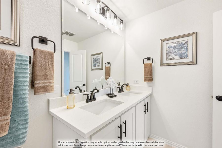 Bathroom with double sink vanity, white cabinets, quartz countertop, and large mirror with track lighting above Bathroom with double sink vanity, white cabinets, quartz countertop, and large mirror with track lighting above