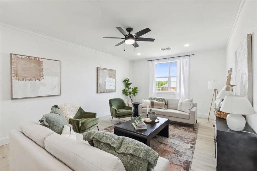 Living area featuring ornamental molding, ceiling fan, wood finished floors, and recessed lighting