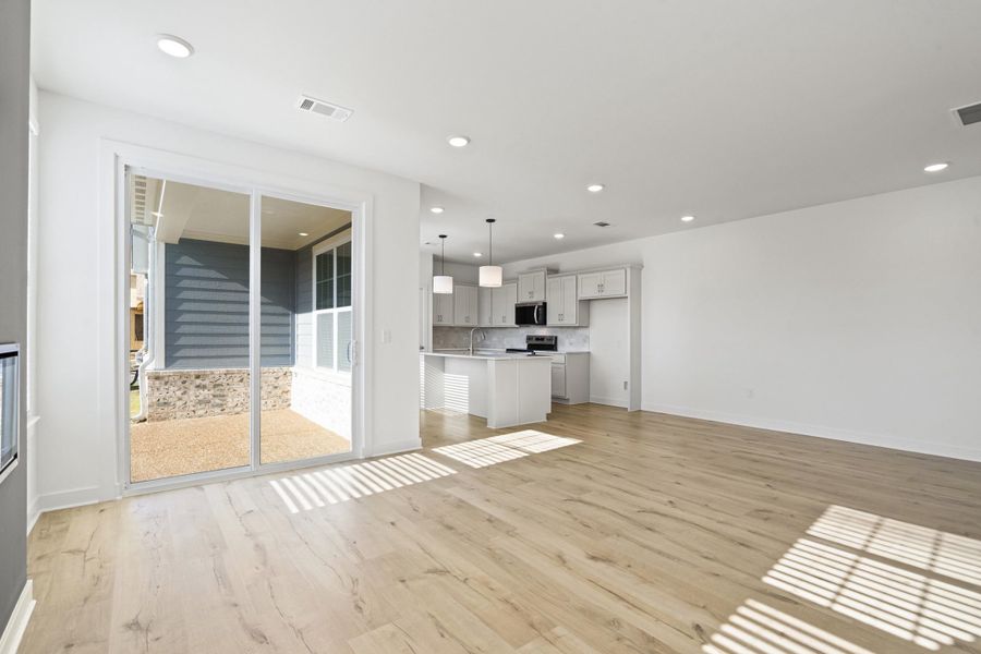 Unfurnished living room featuring light wood finished floors and recessed lighting
