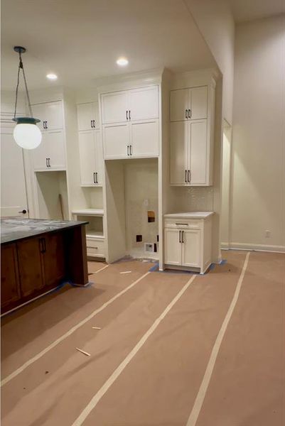 An abundance of cabinets, laid out for full function and ease, all the way to the ceiling.