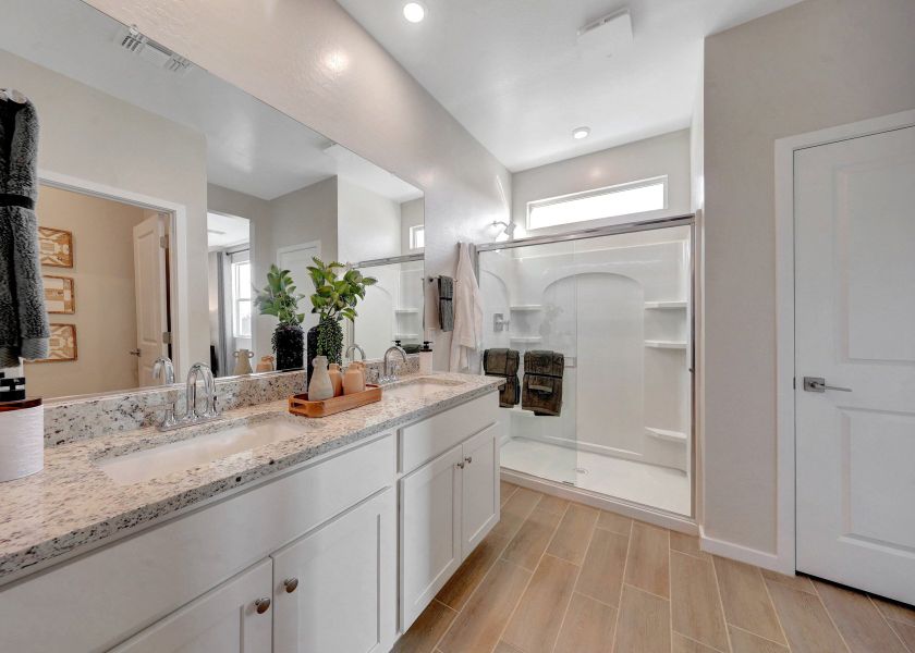 A bathroom with a large mirror.
