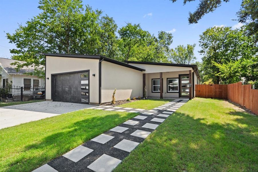 View of front of house with driveway, stucco siding, and an attached garage View of front of house with driveway, stucco siding, and an attached garage