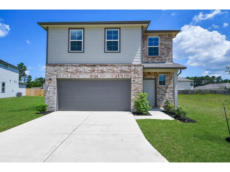 Front exterior of a new home in Liberty Estates, Cleveland, TX, highlighting curb appeal (Image 1). Front exterior of a new home in Liberty Estates, Cleveland, TX, highlighting curb appeal (Image 1).