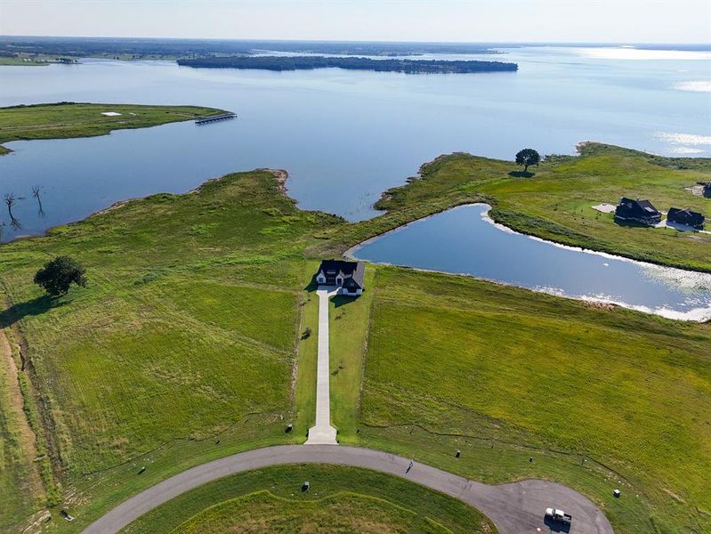 Aerial view of property and surrounding area with a large body of water Aerial view of property and surrounding area with a large body of water