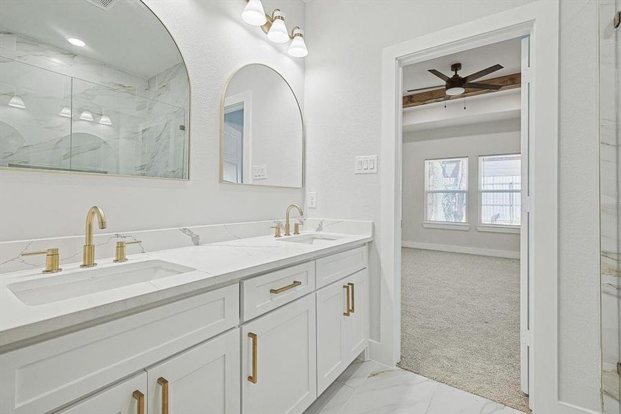 Bathroom featuring vanity, an enclosed shower, and ceiling fan