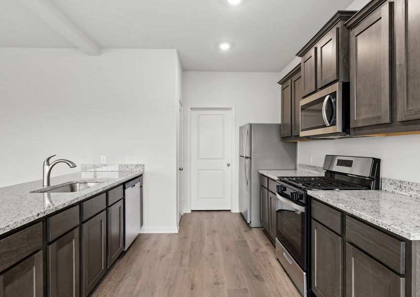 The kitchen has a beautiful wood cabinetry.