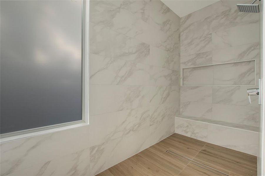 Bathroom featuring tiled shower