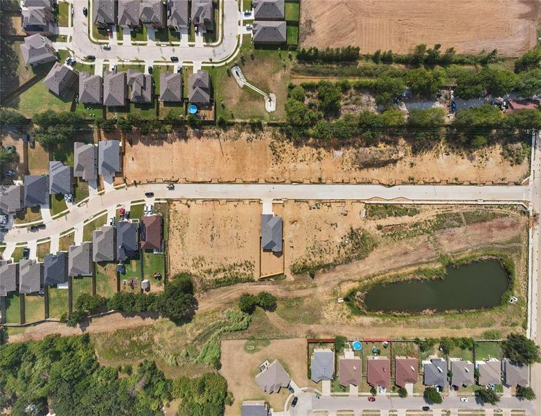 Aerial overview of property's location featuring nearby suburban area and property parcel outlined