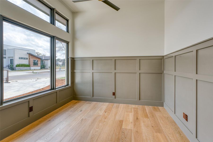 The spacious study features wainscotting and beautiful hardwood floors