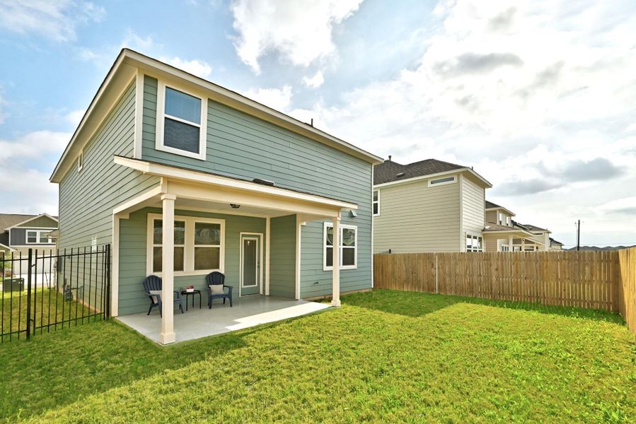 Rear view of property featuring a fenced backyard and a patio area