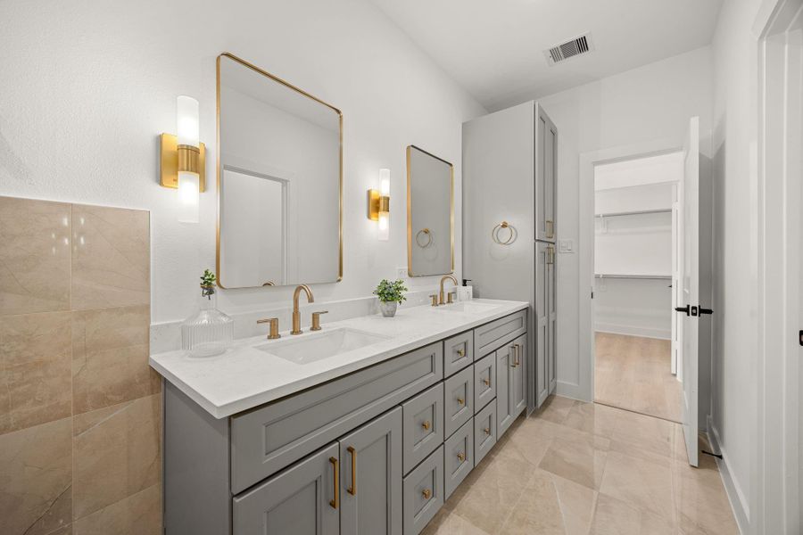 This primary bathroom is definitely move-in ready! Featuring grey cabinets with light countertops, spacious walk-in closet with shelving, high ceilings, neutral paint, sleek and modern finishes. This primary bathroom is definitely move-in ready! Featuring grey cabinets with light countertops, spacious walk-in closet with shelving, high ceilings, neutral paint, sleek and modern finishes.